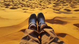 person sitting in desert - learning at home