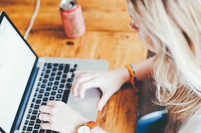 teen writing using a laptop