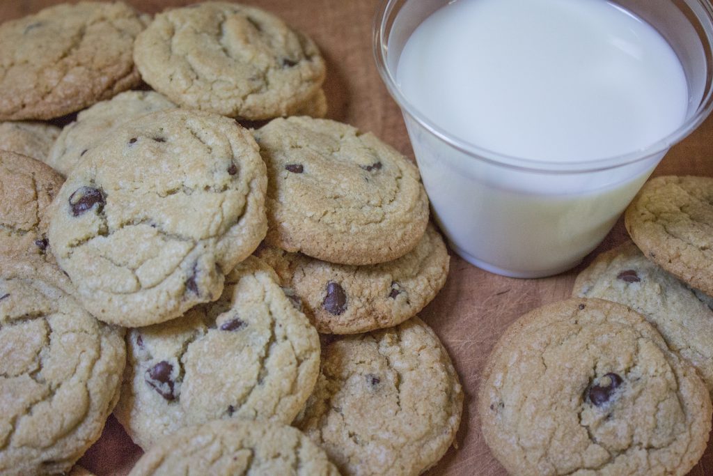 Glass of milk with freshly baked delicious chocolate chip cookies