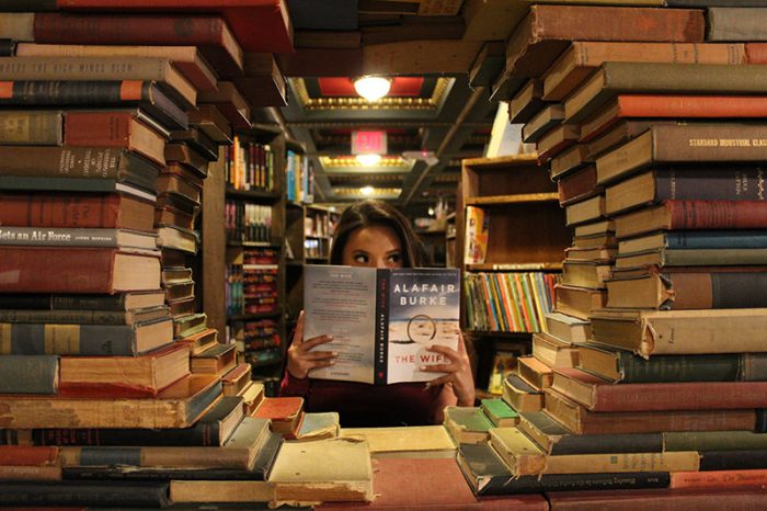 Woman in library surrounded by books