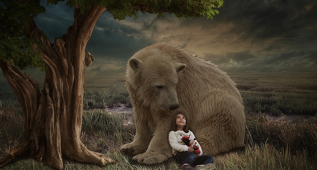 girl next to a large brown bear