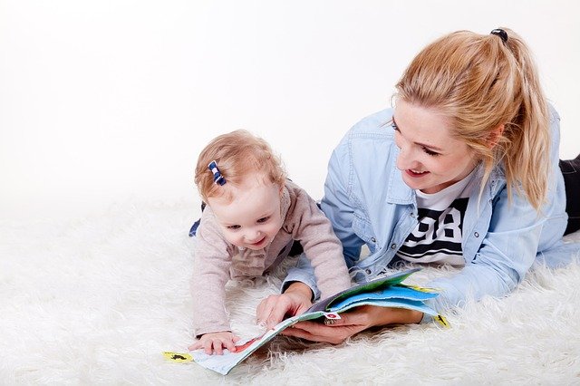 mother reading to her little daughter